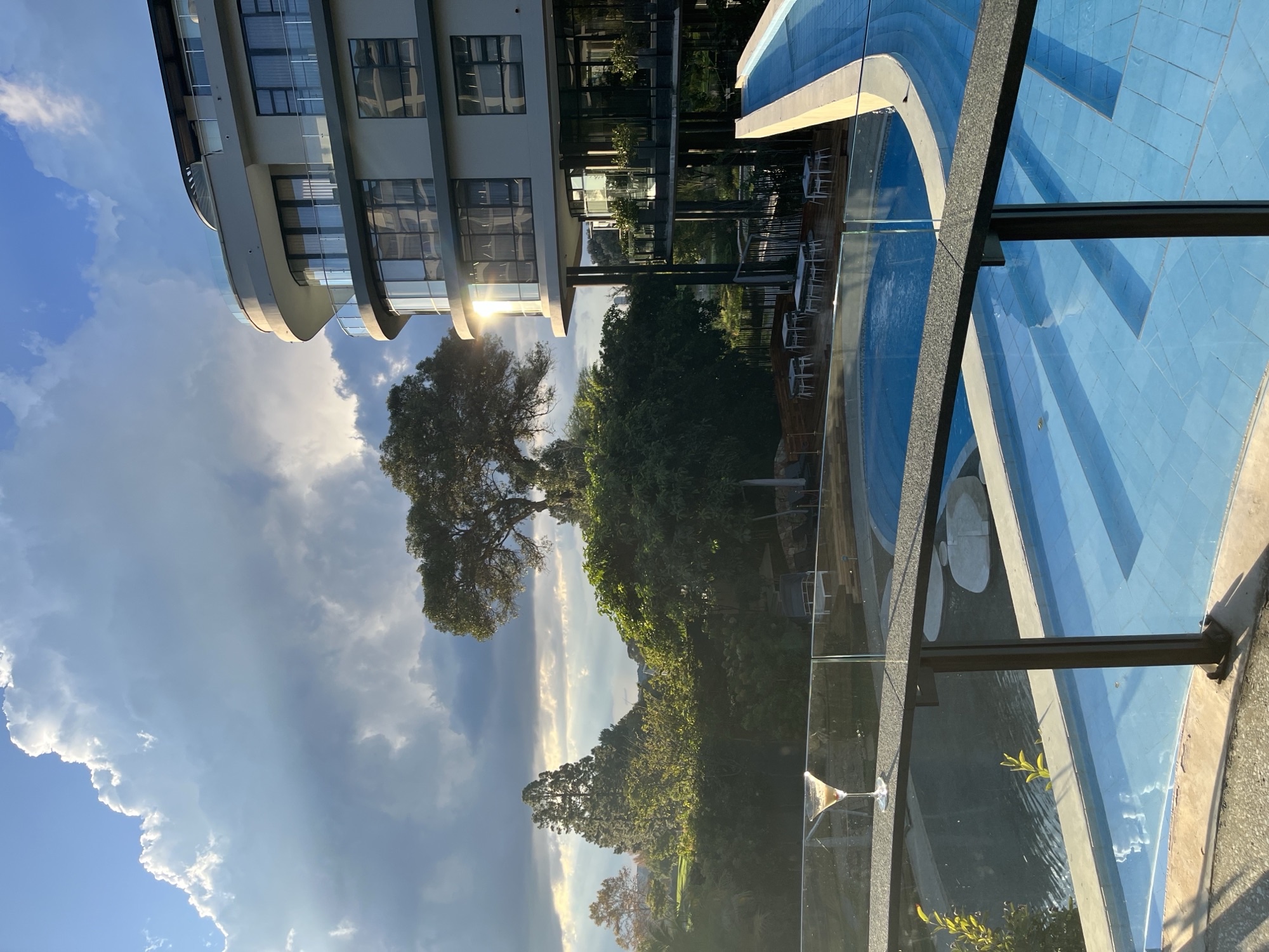 Modern building with infinity pool at golden hour